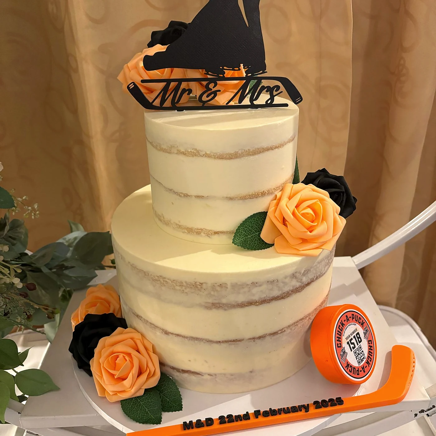 Black ice hockey wedding topper in use on the couple's wedding cake