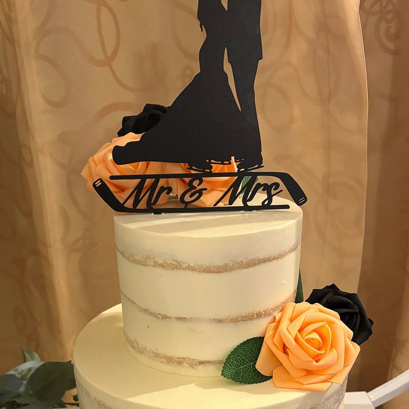 Close detail of the finished Mr and Mrs topper on the wedding cake