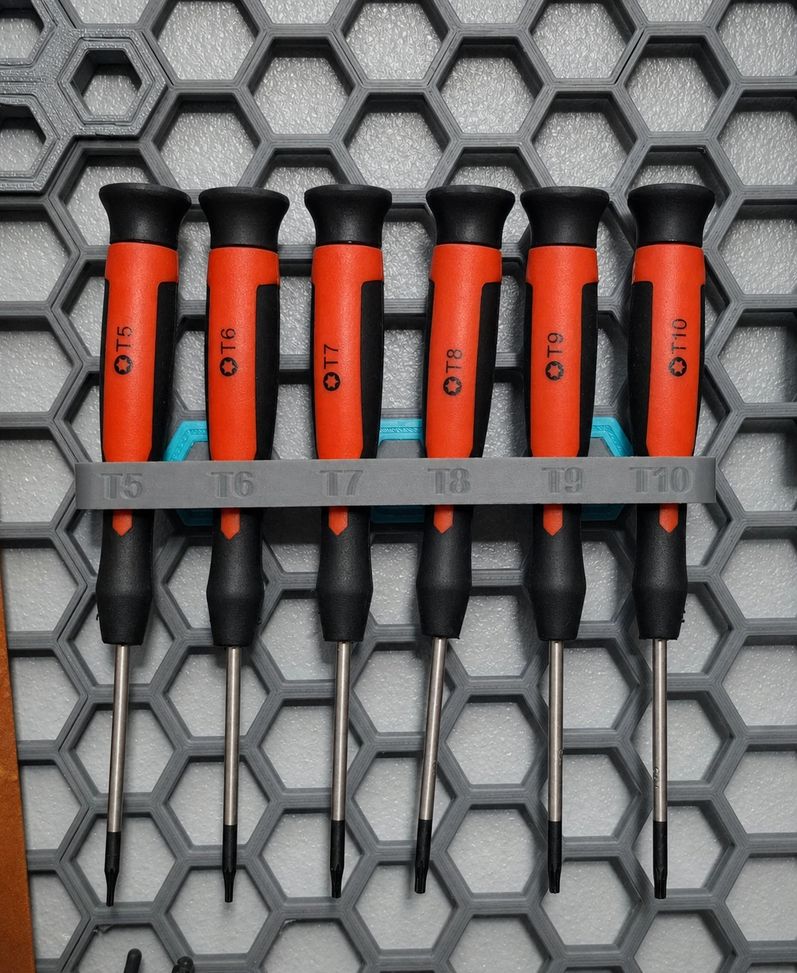 Honeycomb wall-mounted screwdriver holder with six Torx drivers
